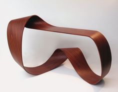 a sculpture made out of wood on a white surface