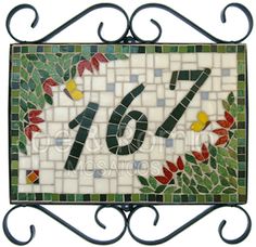 a sign that has the number seventy seven on it and is decorated with colorful flowers