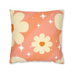 an orange and white flower pillow with stars on the bottom, in front of a striped background