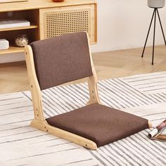 a brown chair sitting on top of a white rug