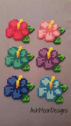 four different flowers made out of perler beads