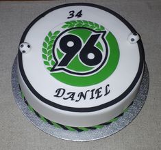 a white cake with green and black frosting on the top that says danfe