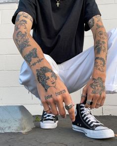 a man with tattoos on his arms and fingers