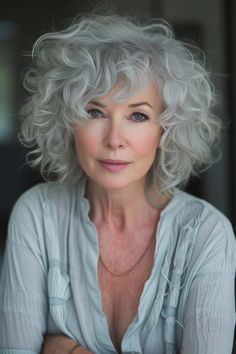 A curly shaggy bob in an ash grey tone is a fashionable and modern choice for women over 60. The cool grey shade complements the relaxed shaggy cut, creating a look that’s both trendy and sophisticated. Short Wolf Haircut, Scrunchie Bun, Shaggy Cut, Grey Hair Journey, Long Natural Curly Hair, Long Silver Hair, Short Curly Hairstyles For Women, Grey Hair Transformation