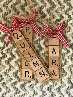 two scrabble tiles with words spelling q is for quaran