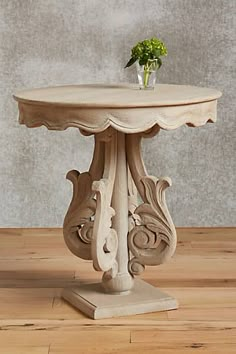 a small table with a vase on top