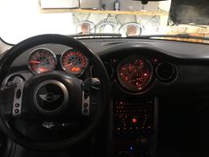 the interior of a car with gauges and dash lights