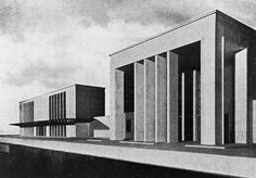 black and white photograph of the exterior of a building with columns on each side, in front of an overcast sky