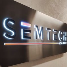 the semt tech sign is lit up in front of a wall that reads semetch