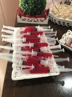 several toothbrushes are lined up in plastic containers on a table next to a potted plant