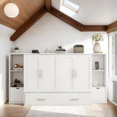 an empty room with white furniture and wood beams on the ceiling is pictured in this image