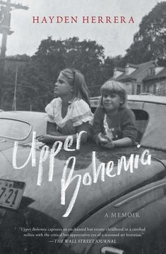 an old photo of two children sitting on the hood of a car