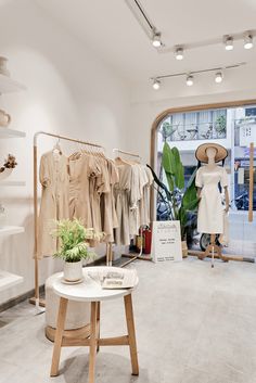 the inside of a clothing store with mannequins on display