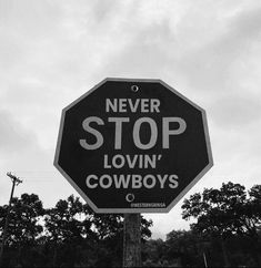 a black and white photo of a stop sign with the words never stop lovin'cowboys written on it