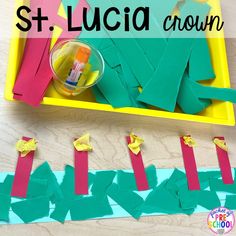 st lucia crown made out of construction paper on a wooden table with scissors and glue