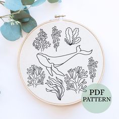 a hand embroidery pattern with an image of a whale surrounded by seaweed and corals