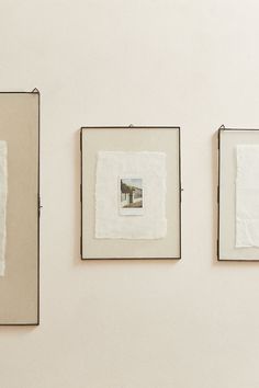 three framed photographs hang on the wall next to each other