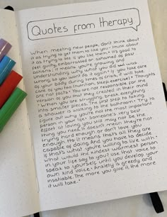 an open notebook with writing on it next to colored markers