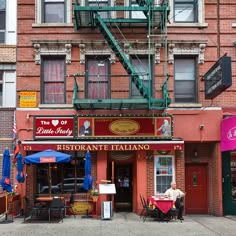 an italian restaurant on the corner of a street in front of a red brick building