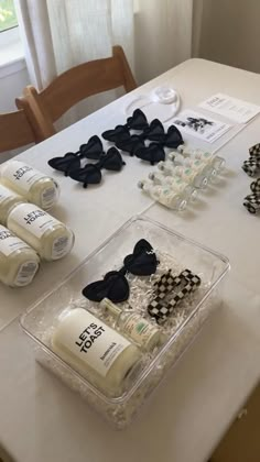 the table is set up with black and white items for making bow ties on them