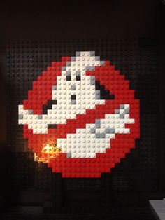 a lego artwork made to look like mario's face and mouth is shown in the dark