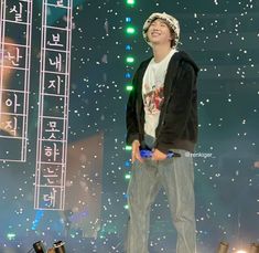 a young man standing on top of a stage