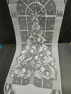 a christmas tree is on the back of a car seat with black and white fabric