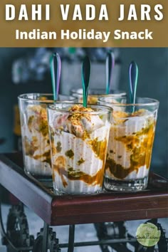 three glasses filled with food sitting on top of a table