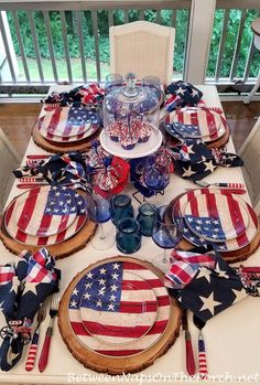 an american flag table setting with plates and utensils