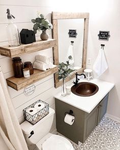 a bathroom with a toilet, sink and shelves