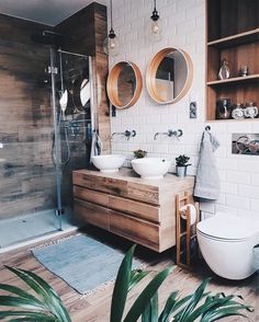 a bathroom with two sinks, a toilet and a shower in the middle of it