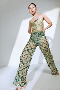 Glam up this season with the perfect embellished sequin pants for your next night out in the city. Pair it with one of our bustiers or corsets to complete the look. Hand-embroidered sequin pattern Straight pants High-waisted Semi-sheer Knitted underpants in green Concealed zipper on the side Fabric: Net Model wears a size XS. Materials used: Net Product care: Dry clean only. DO NOT steam the leather. To iron the piece, place a piece of cotton or muslin fabric on the piece to press. DO NOT iron d Sheer Pant, Corset Pants, Sheer Pants, Sequin Pattern, Sequin Pants, Muslin Fabric, Bustiers, Corsets, Straight Pants