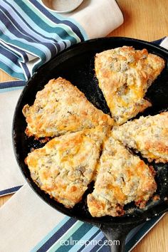 four biscuits in a cast iron skillet on a table