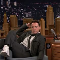 a man in a suit and tie laying on a chair