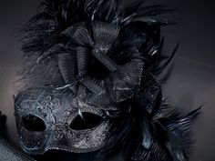 This captivating set includes two stunning masks, both designed in the classic Venetian style. The women's mask is adorned with fishnet, lace fabric, and feathers while the men's mask has shimmer. From masquerade balls to themed celebrations, our couples mask set is the perfect choice for any look! Age Group/Gender - Adult/Unisex Size/Type - One size fits all adults Mask Color - Black Women Mask - Black with lace overlay and black feathers and tulle flower Men Mask - Black with filigree glitter Full Face Masquerade Mask For Halloween Party, Full Face Halloween Masquerade Mask For Party, Elegant Halloween Masquerade Masks And Prosthetics, Feathered Masquerade Mask For Carnival Party, Elegant Eye Mask Masquerade For Costumes, Elegant Full Face Masquerade Mask For Carnival, Elegant Masks For Carnival And Halloween, Elegant Eye Mask For Masquerade Costume, Carnival Evening Eye Mask