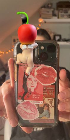 a person holding up a cell phone case with an apple on top of the cover