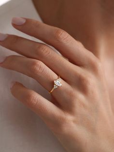 a woman's hand with a diamond ring on it