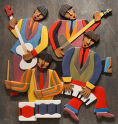 an image of three men playing the guitar and singing on paper cutout art pieces