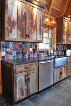 an old kitchen with rusted cabinets and stainless steel appliances in the middle of it