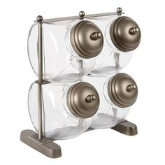 three glass jars are stacked on a metal stand