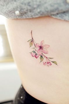 a woman's stomach with pink flowers on it