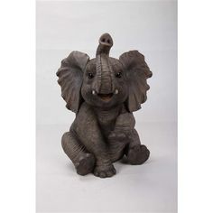 an elephant figurine sitting on the ground