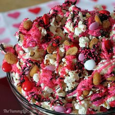 pink popcorn party mix in a glass bowl