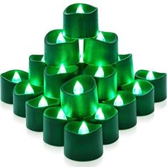 green tealight candles are arranged in the shape of pyramids