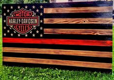 an american flag made out of wood with the harley davidson logo painted on it's side