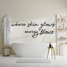 a bathroom wall decal with the words invest in yourself daring written on it next to a bathtub