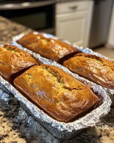 four loafs of banana bread sitting on top of a counter