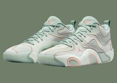 the nike air foam penny is in mint green and white with pink accents on the upper part