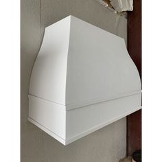 a white stove hood mounted on the side of a wall