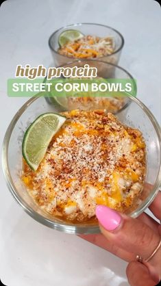 a hand holding a bowl of food with limes on it and the words high protein street corn bowls